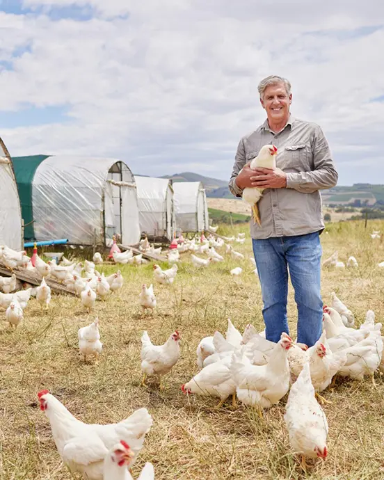 Farmer standing near chickens